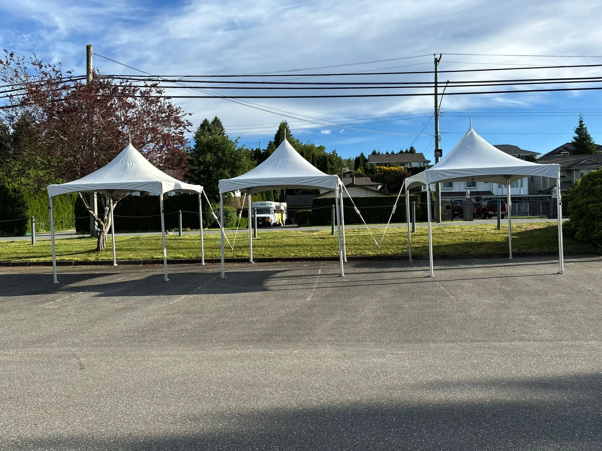 Three white high-peak tents arranged in a row